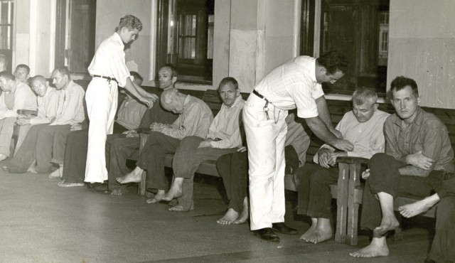 Conscientious objectors (in white) attend to patients in the mental unit of Cleveland State Hospital during World War II. With 2,800 patients in 1945, the hospital was 600 over its capacity. “The hospital had a poor reputation with respect to patient care,” according to The Civilian Public Service Story at http://civilianpublicservice.org, “Workers had to fight cockroaches and filth in overcrowded wards, and [non-CPS] attendants controlled patients by shouting and beatings. The ‘incontinent and violent’ wards lacked sufficient supplies or activities for patients and experienced reports of injuries to patients and employees.”
