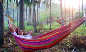 Essayist Lani Prunés, class of 2014, relaxes at the end of her first day of marching in the hammock that will serve as her overnight accommodation. (Photo by Randi Hagi)