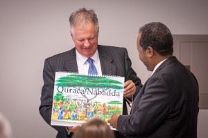EMU President Loren Swartzendruber presents Somalia President Hassan Sheikh Mohamud with materials produced by EMU for trauma-healing work in the Somali language.