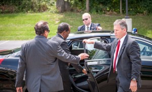 President Mohamud departs, assisted by U.S. Secret Service members. 