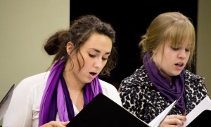 Sarah Sutter (left) and Lauren Sauder in a rehearsal with Eastern Mennonite University’s Chamber Singers, directed by Ken J. Nafziger. (Photo by Randi Hagi)
