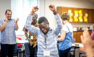 Here celebrating with Summer Peacebuilding Institute classmates, Lassana Kanneh shares an irrepressible spirit for helping his fellow humans heal from great harms and trauma. (Photo by Michael Sheeler)