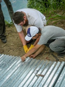 Nate Koser works with a Nepali man on construction of housing.