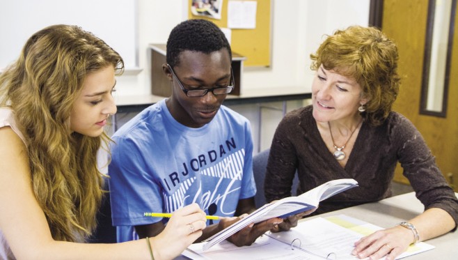 Cathy Smeltzer Erb (right), chair of EMU’s undergraduate education department, confers with two education students. 