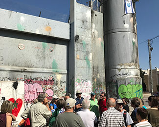 People in front of a wall in Israel/Palestine