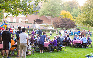 many people at tables on the EMU lawn