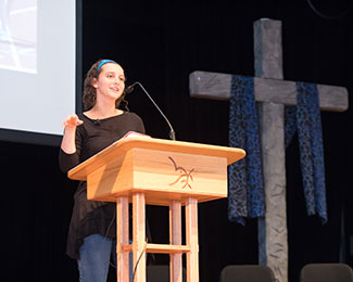 student speaking in chapel