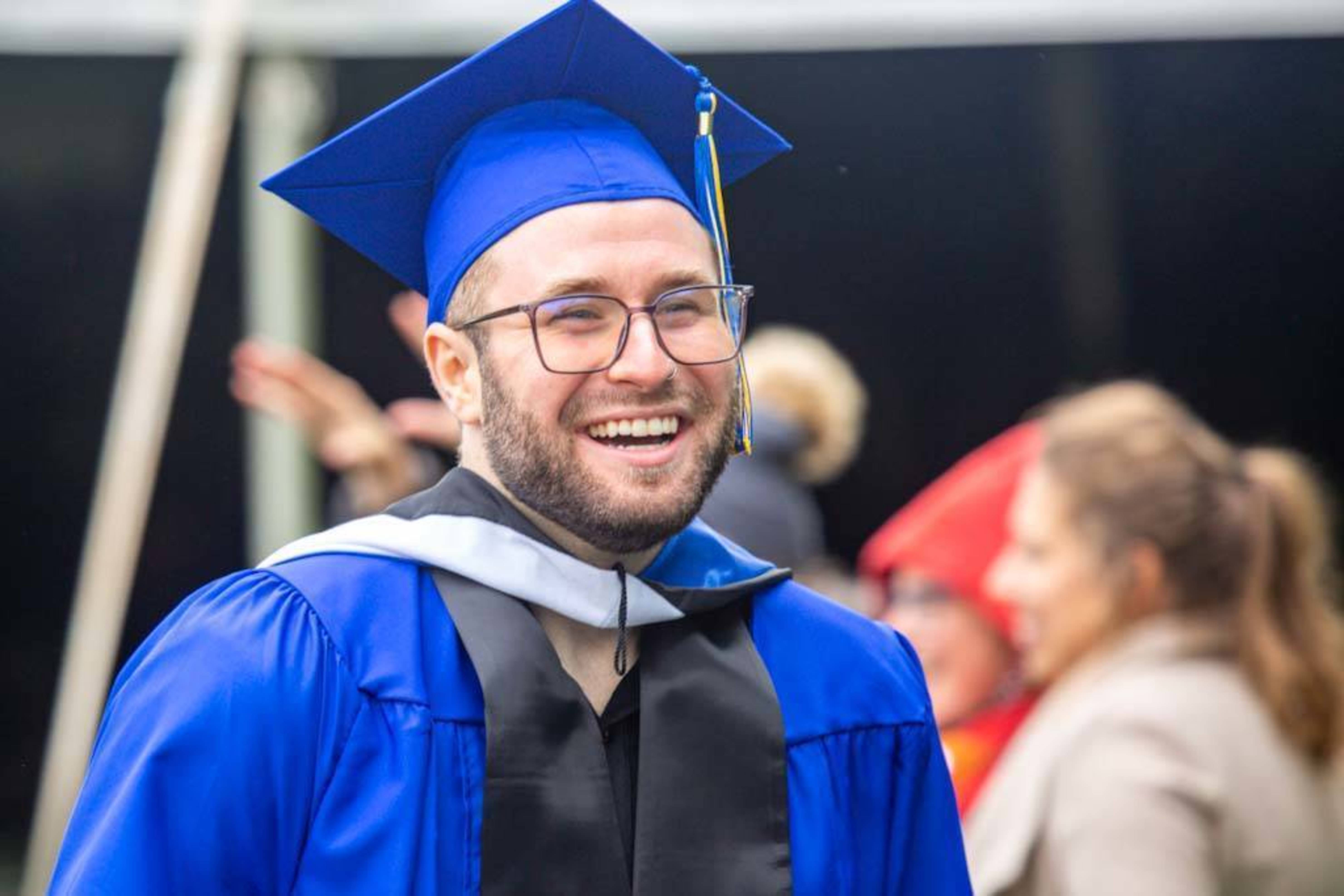 a graduating student laughs