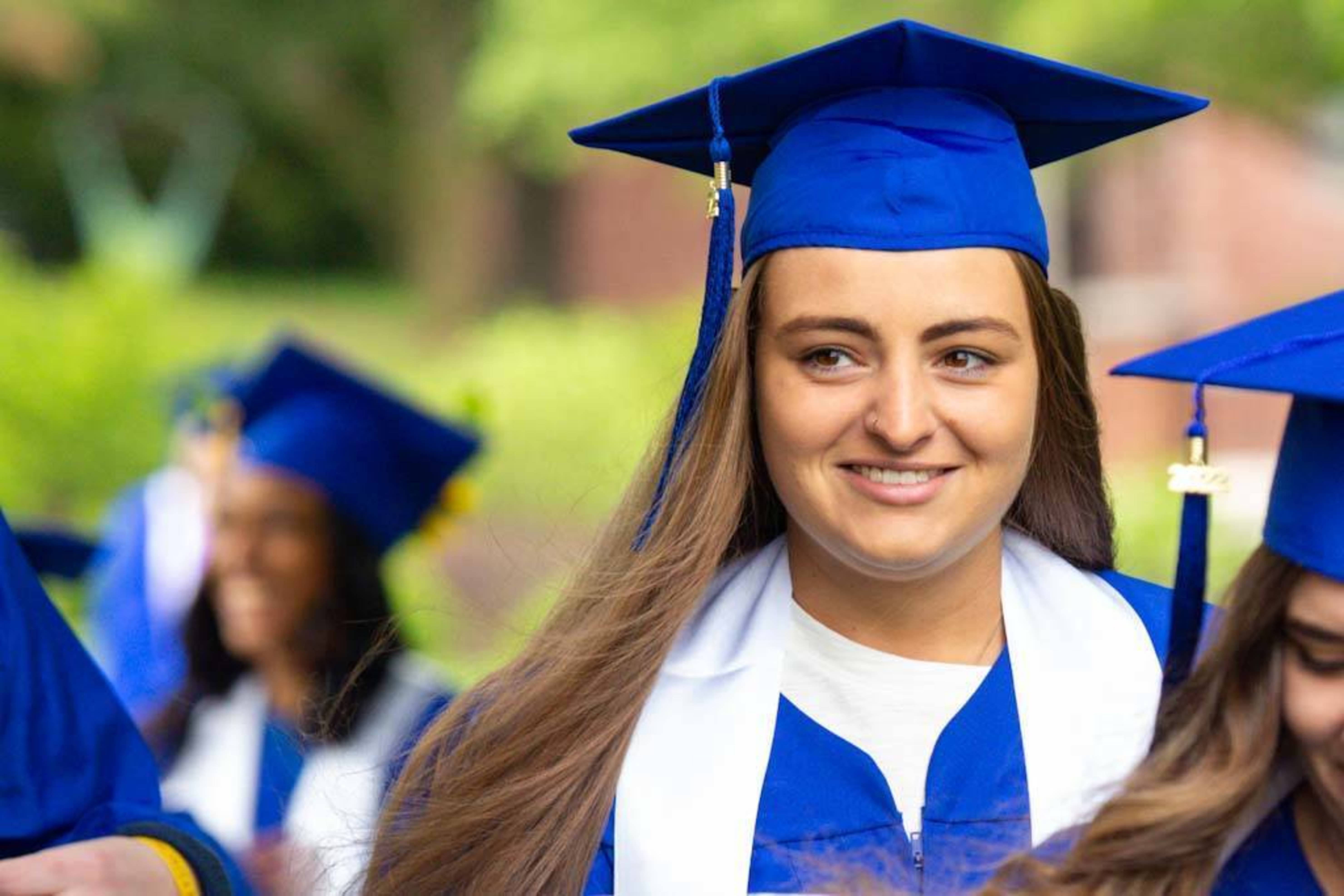a graduating student smiles