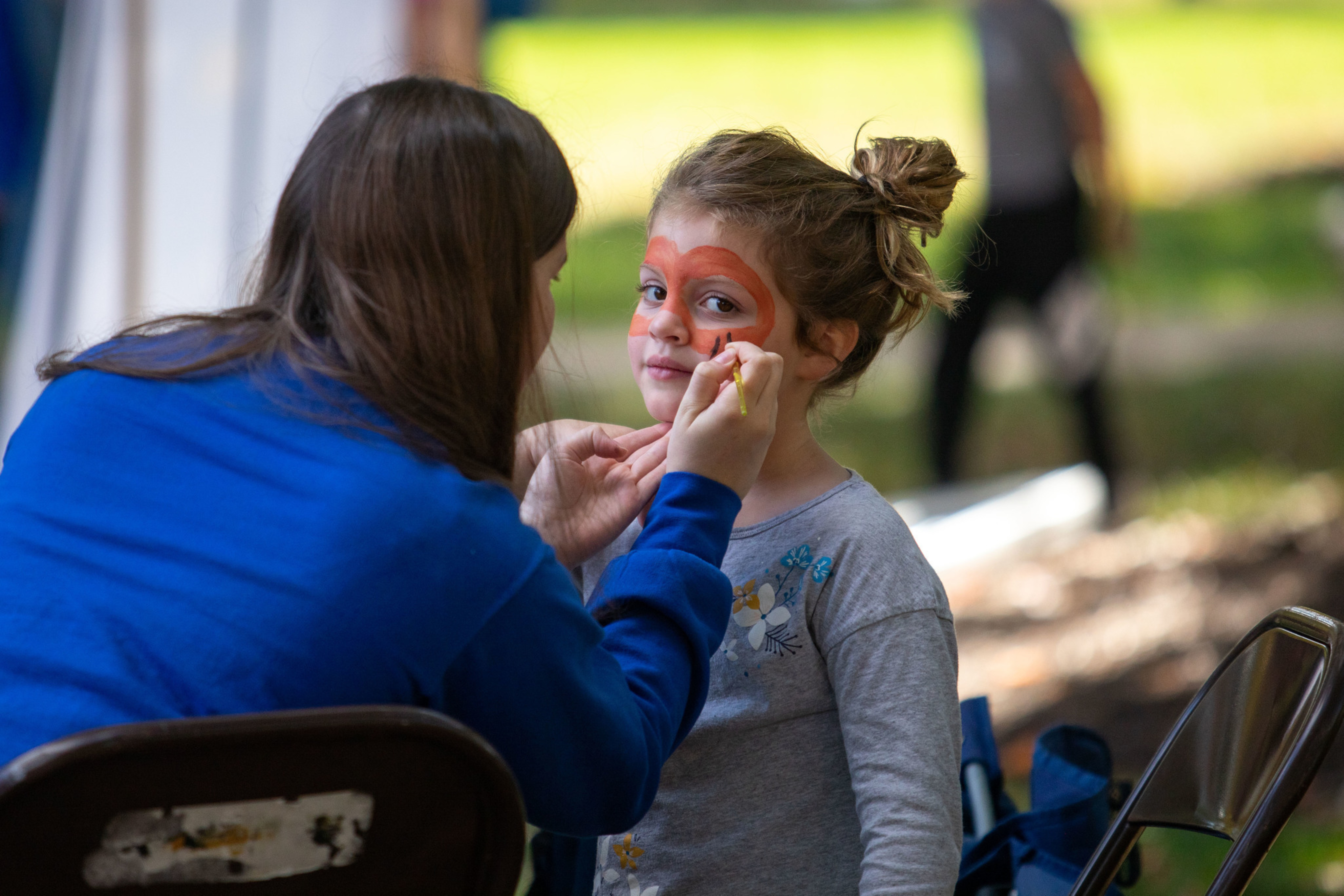 a child gets their face painted