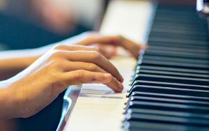 hands and piano keyboard