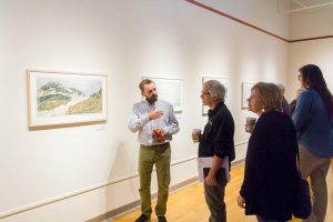 Artist Todd Anderson talks with attendees at the Feb. 3 opening of his exhibit. Anderson is a professor at Clemson Univer