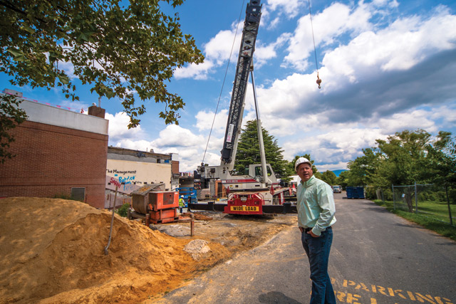 Vice president for finance Daryl Bert '97 was caught by a photographer one July afternoon, wearing a hard hat and jeans as he personally checked out the progress of construction at the Suter Science Center. The crane is adjacent to Suter's former "head room." Photo by Michael Sheeler 