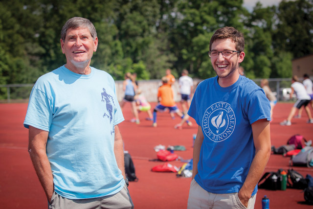 At age 67, Jim Ryun (left) jogs two or three times a week and bikes when he can - plus joins his campers in playing Ultimate Frisbee - but he mostly focuses on nurturing upcoming runners, such as the high schoolers coached by EMU junior Tyler junior Tyler Eshleman (right). 
