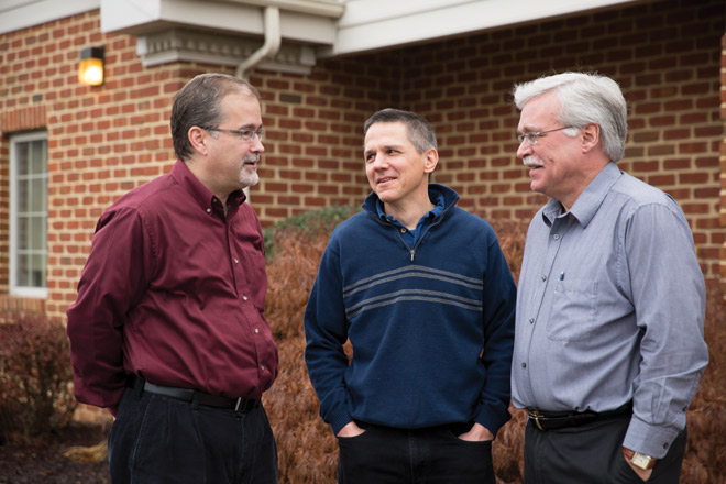 Delbert Wenger, class of '86 (center), is the information systems administrator and accountant at Choice Books' central office in Harrisonburg, where CEO/director John Bomberger ’77 (right) and program assistant Dale Mast ’88 (left) also work. Choice Books sells more than 5.1 million books annually from about 11,350 displays. (Photo by Kara Lofton) 