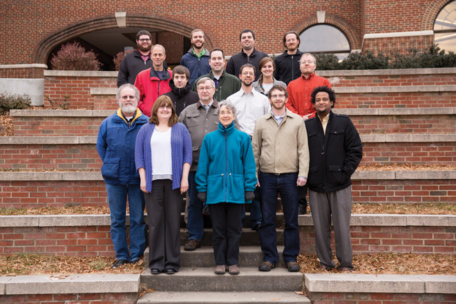 It takes a village of information systems staffers to keep EMU functioning. The six IS personnel in the foreground are, from left: Dan Marple, Jenni Piper, Michael Stauffer, Becky Brenneman, Dan Risser, HB Belay. The six in the middle rows, from left: Marty King (in red jacket), Justin Hershey (in black jacket), Steve Gibbs (in green jacket), Ben Beachy (in white shirt), Krista Nyce, Jason Alderfer. Four in back row: Andrew Crorken, Austin Showalter, Holden Byler, David Penner. Not pictured: Alison D'Silva. (Photo by Kara Lofton)