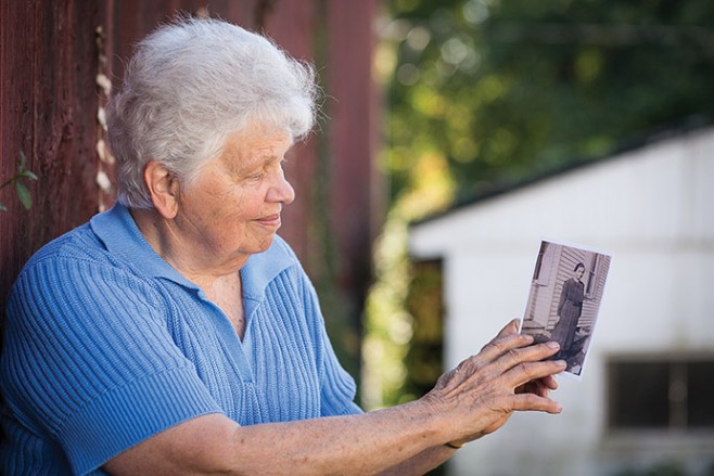Lois M. Martin '62 on her family farm in Lancaster, Pennsylvania, with a photo of her mother Esther Metzler Martin. 