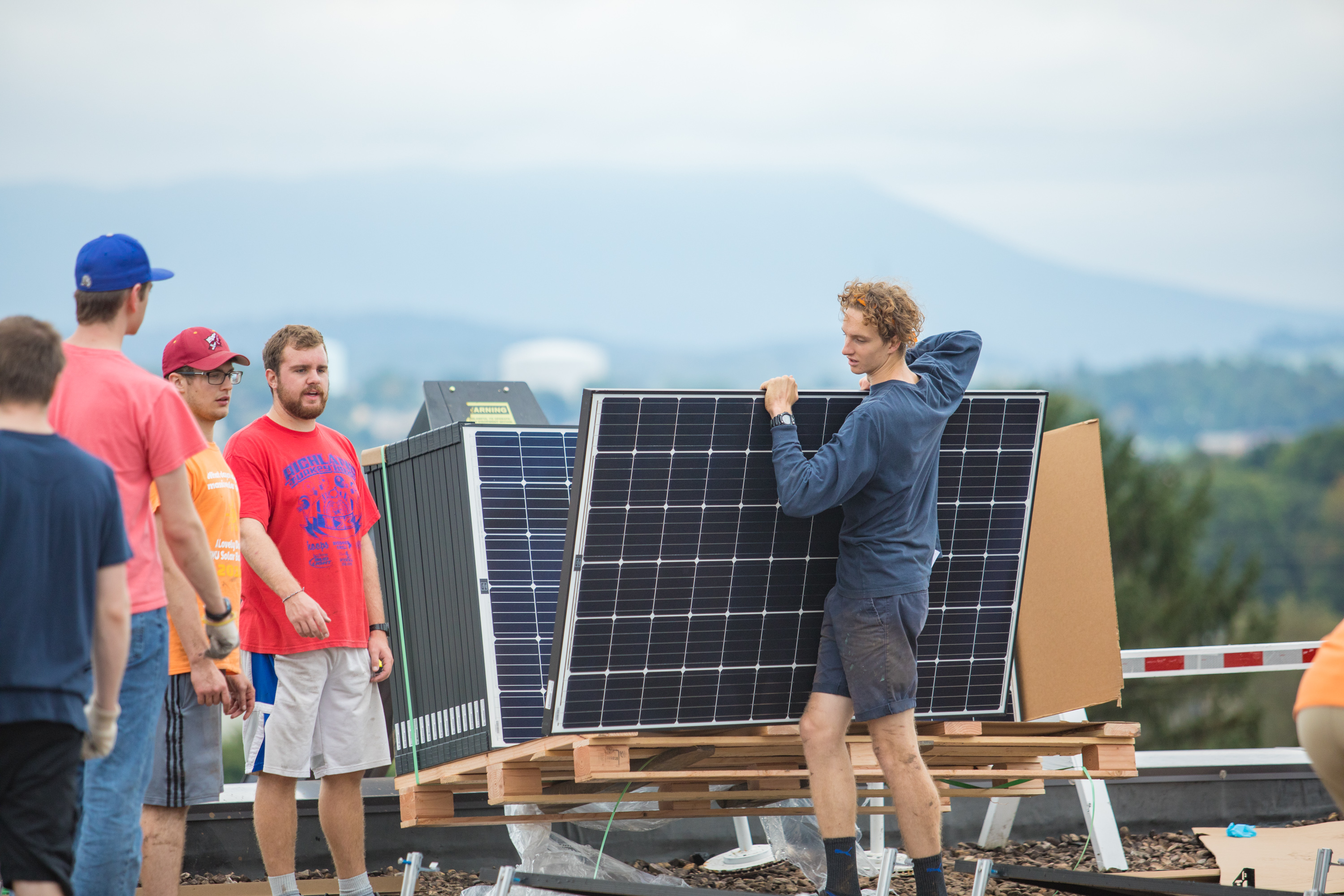 Students installing solar panels