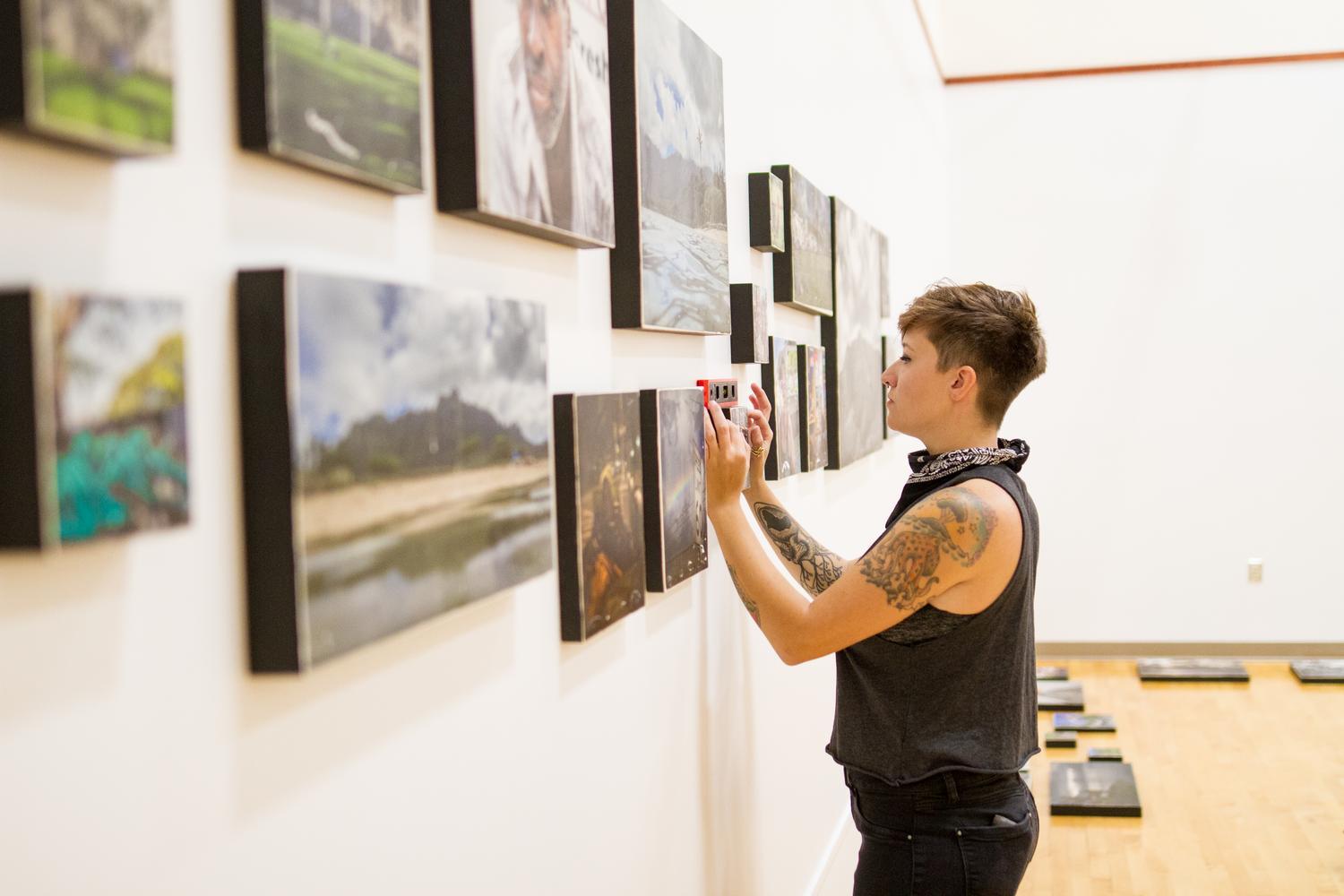 alumni hanging photos in the Gehman Gallery