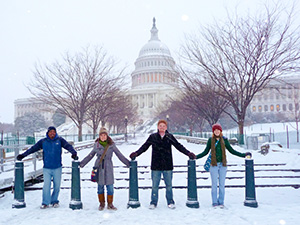 WCSC Students holding hands in front of Capitol in the snow